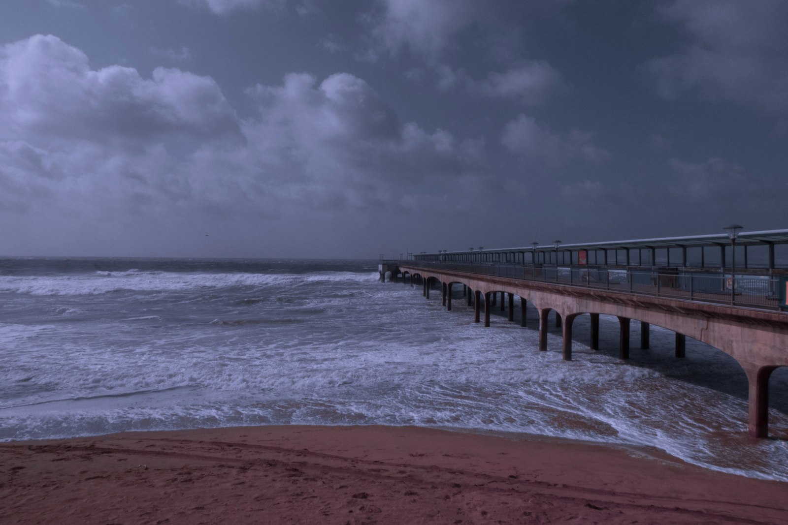 Stock photo of rough ocean water under dark storm clouds, used to illustrate Tropical Storm Isaias watch coverage | Westside Construction Group