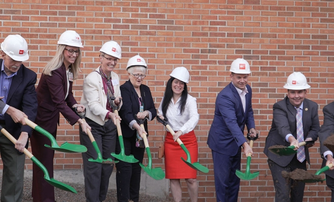 Officials in white hard hats turn dirt at the St. Joseph's Hospital psychiatric unit groundbreaking in Syracuse | Westside Construction Group
