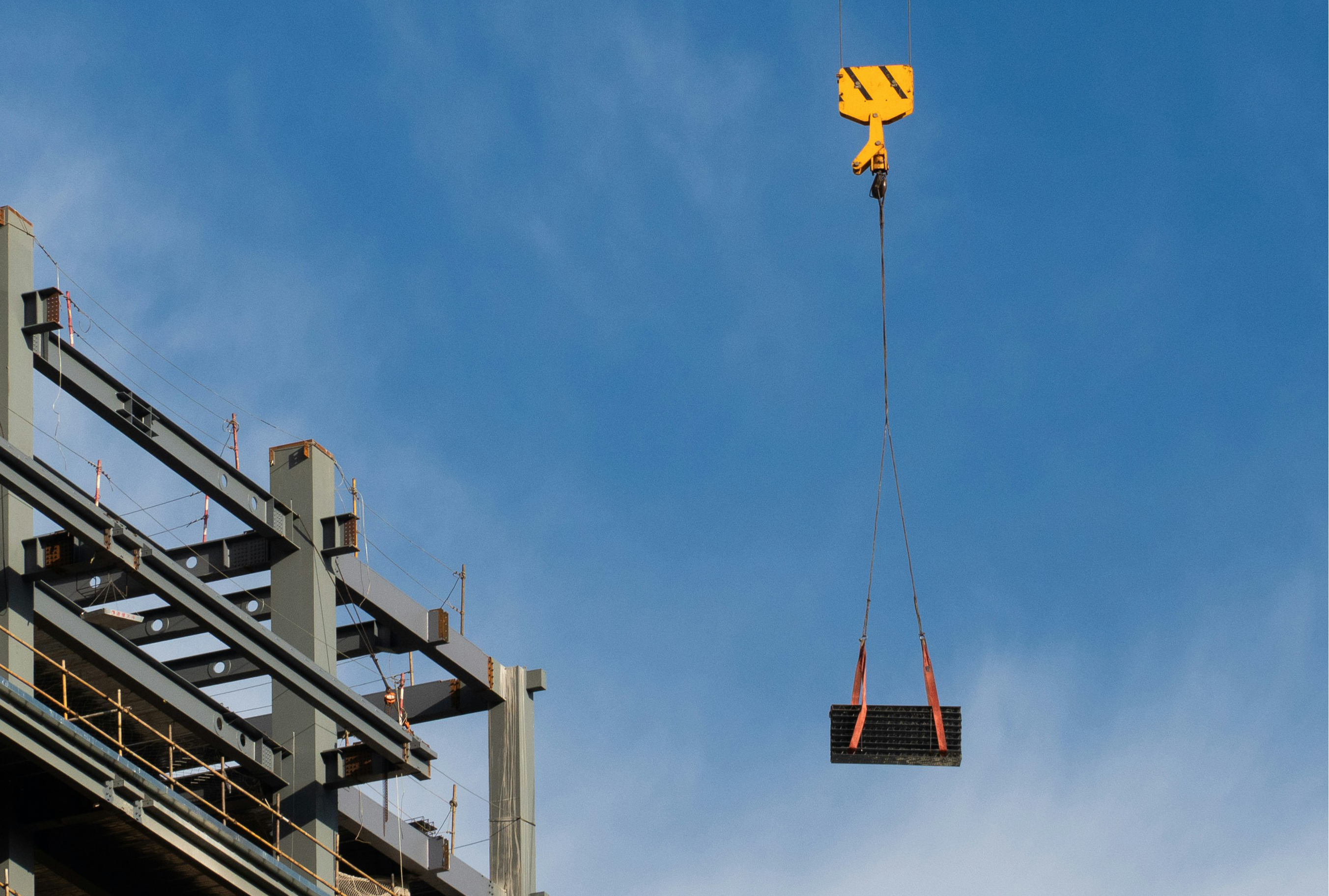 Tower crane above a concrete slab on a large construction site | Westside Construction Group