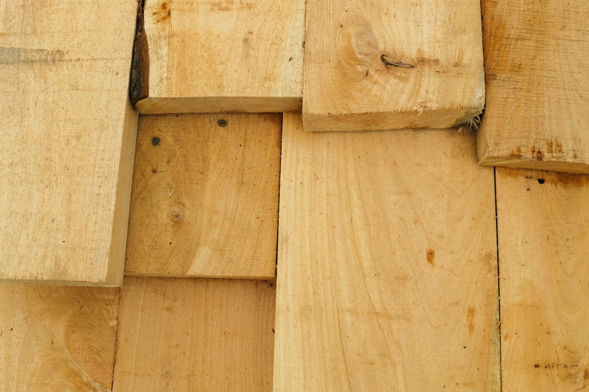 Stacked timber and wood building materials | Westside Construction Group