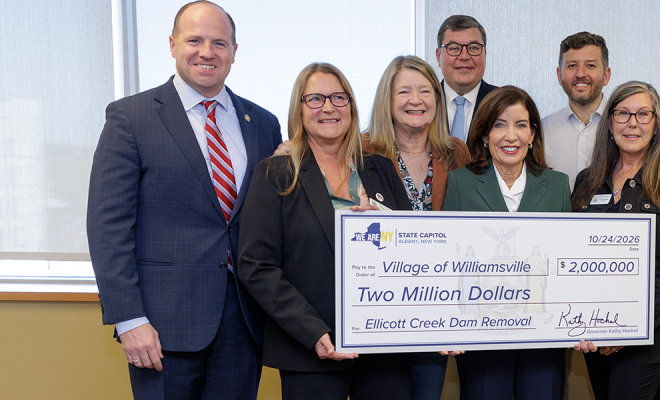 Governor Hochul holding a large check with Western New York officials | Westside Construction Group