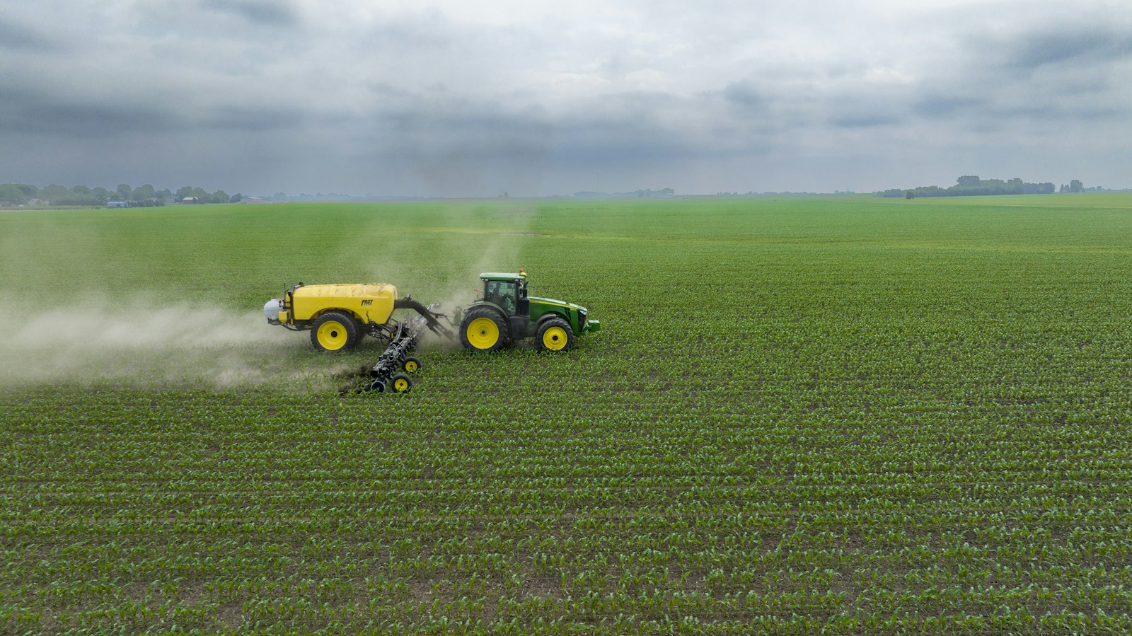 Farm machines working a field, illustrating U.S. fertilizer supply and USDA FIELDS grants | Westside Construction Group