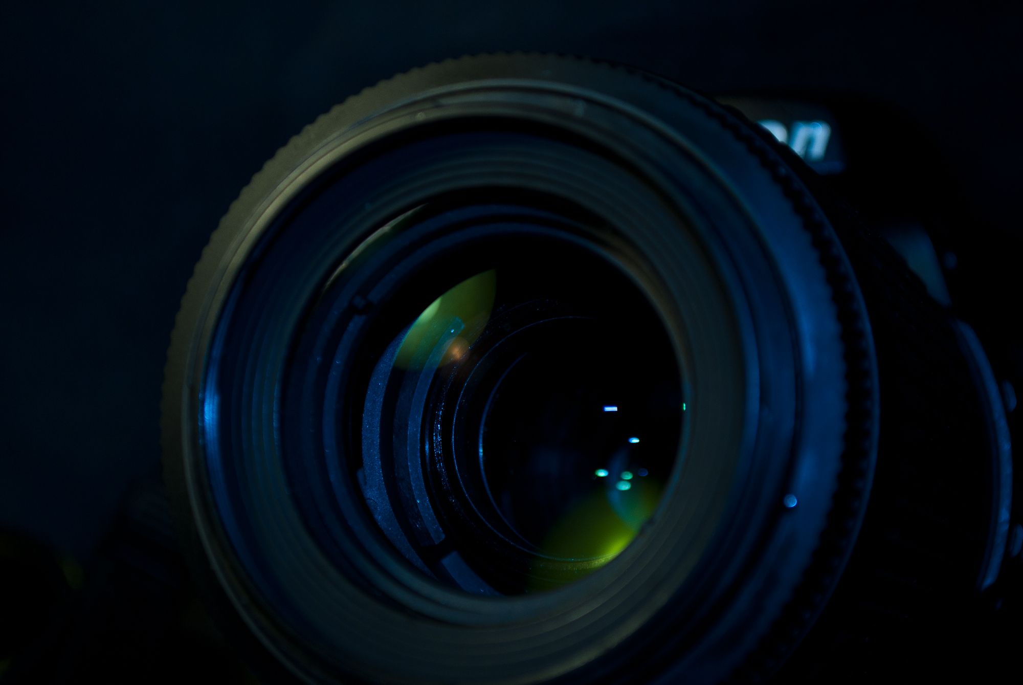 Camera lens shown as an illustrative application context; no use of Mill-Max contacts in the pictured lens is claimed.