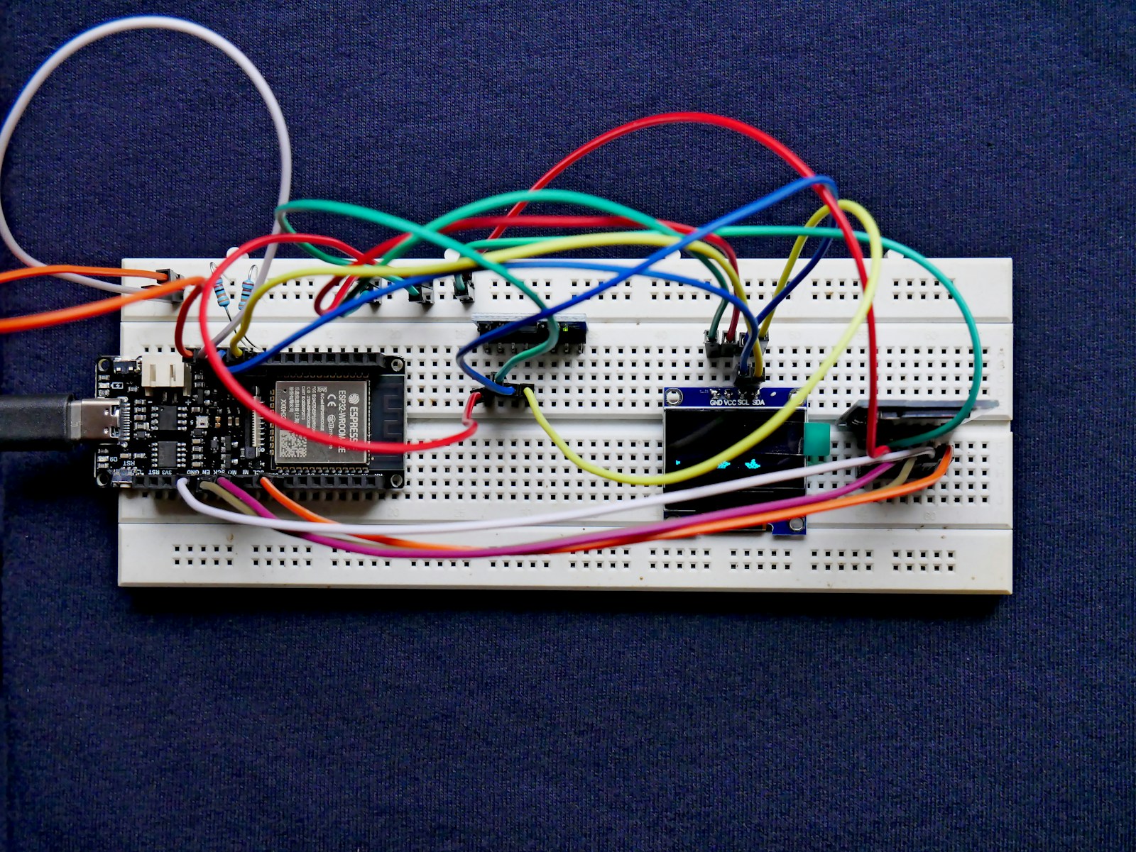 Illustrative embedded-development breadboard with a FireBeetle board, sensor, display and wiring