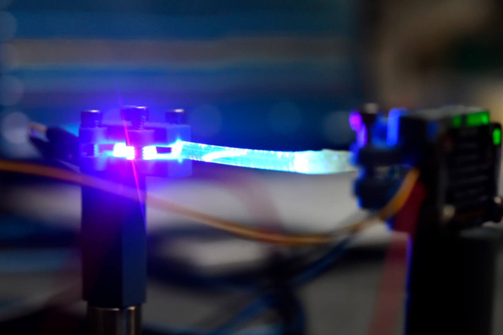 The team’s flexible waveguide glows under ultraviolet excitation.