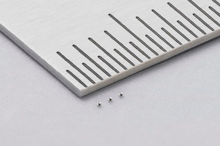 Murata’s NCU01 thermistors beside a millimetre scale.