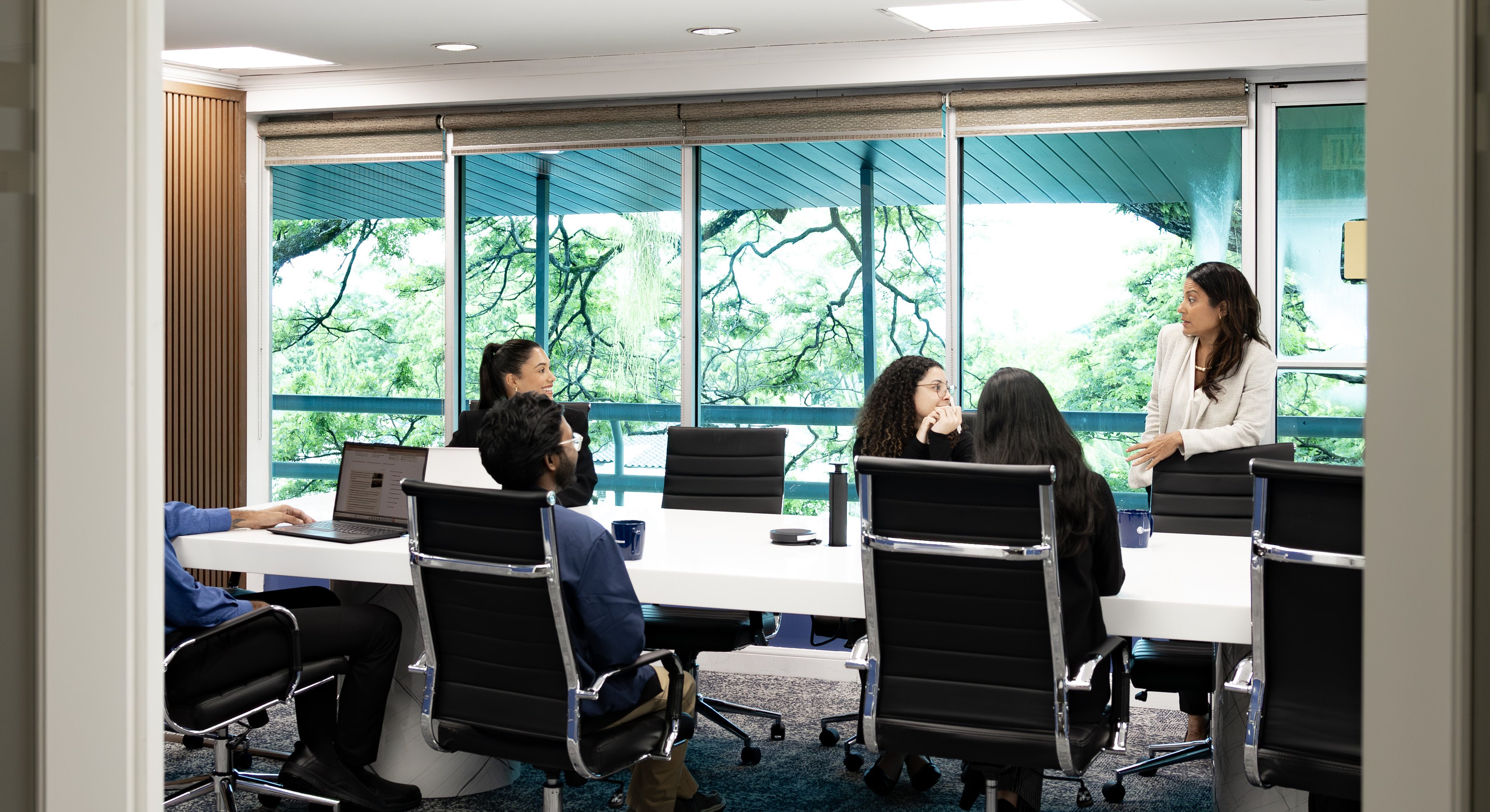 Blewstream finance team reviewing figures in a boardroom meeting