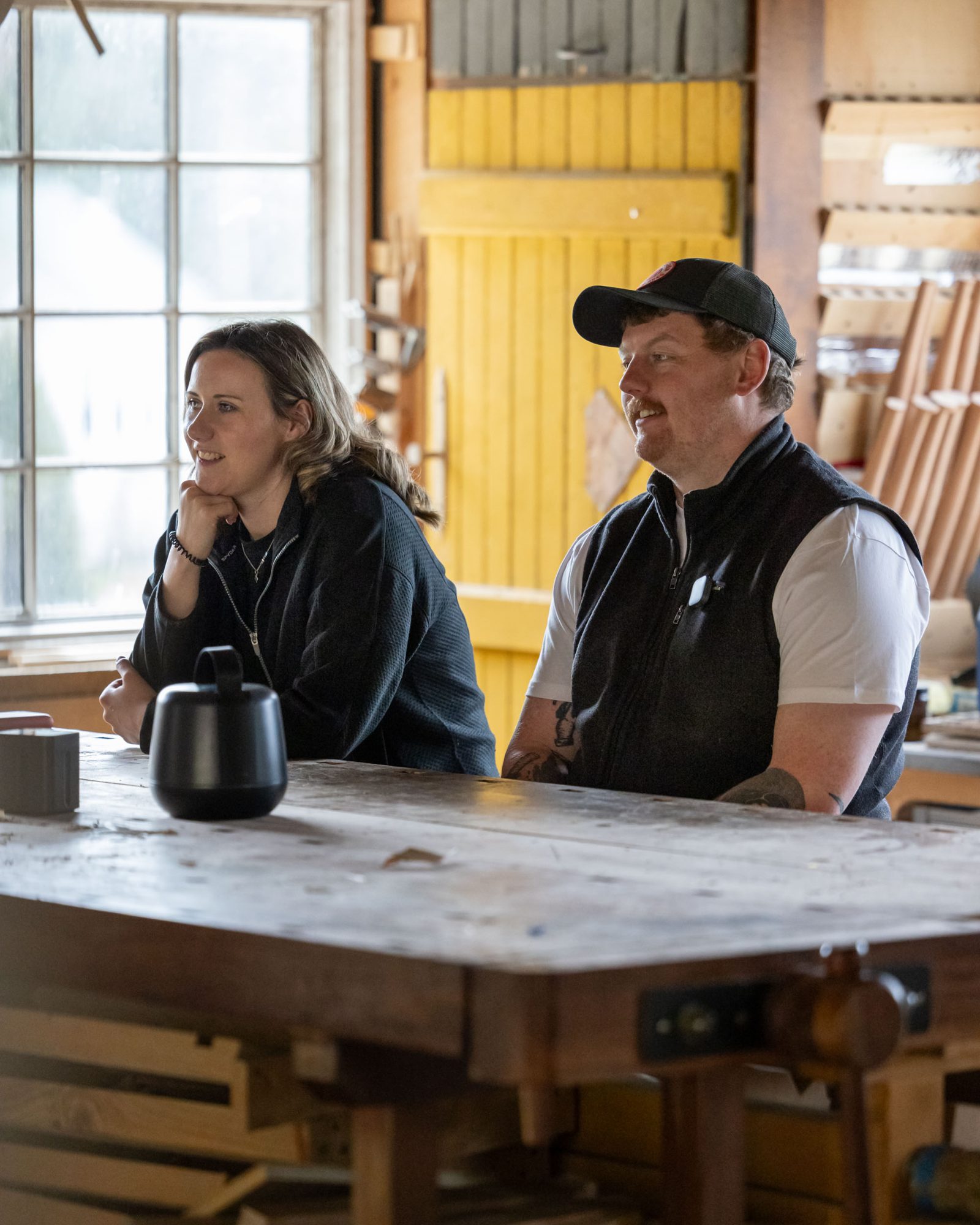 Kate and Jack Lennie in relaxed conversation at a workshop bench, the small Space Recorder beside them