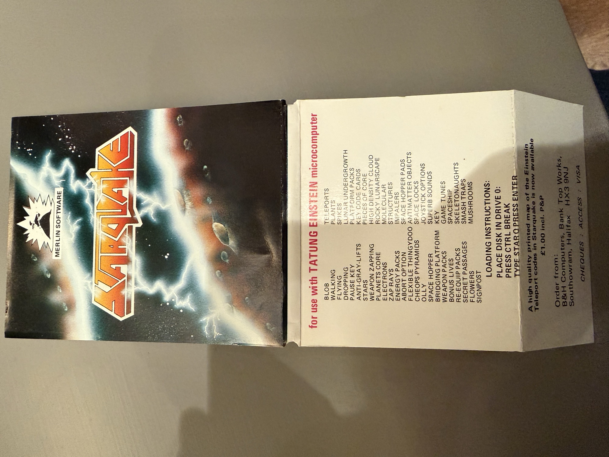 Unfolded inlay, outer side: cover art, the list of game features, loading instructions and an offer of a printed map of the teleport codes from B&H Computers