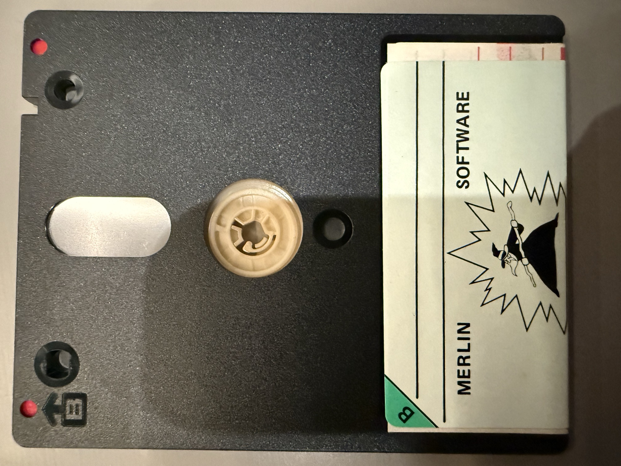 Side B of the 3 inch disc with a Merlin Software label and no title written on it