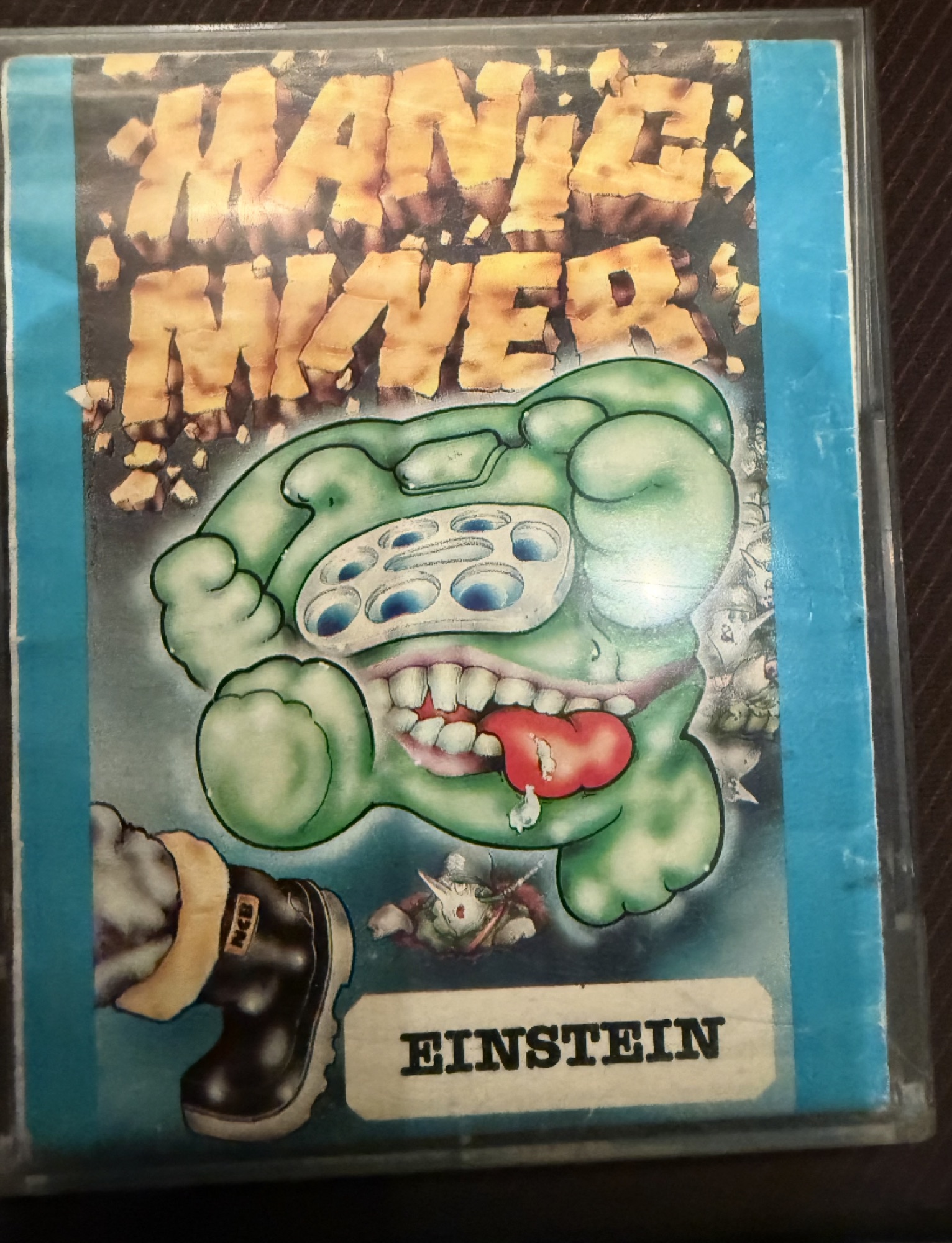 Front of the Manic Miner case: the green monster artwork with an Einstein badge
