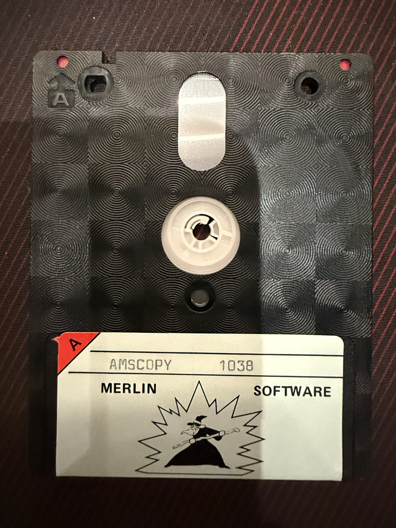 The disc, side A, Merlin Software label typed AMSCOPY 1038