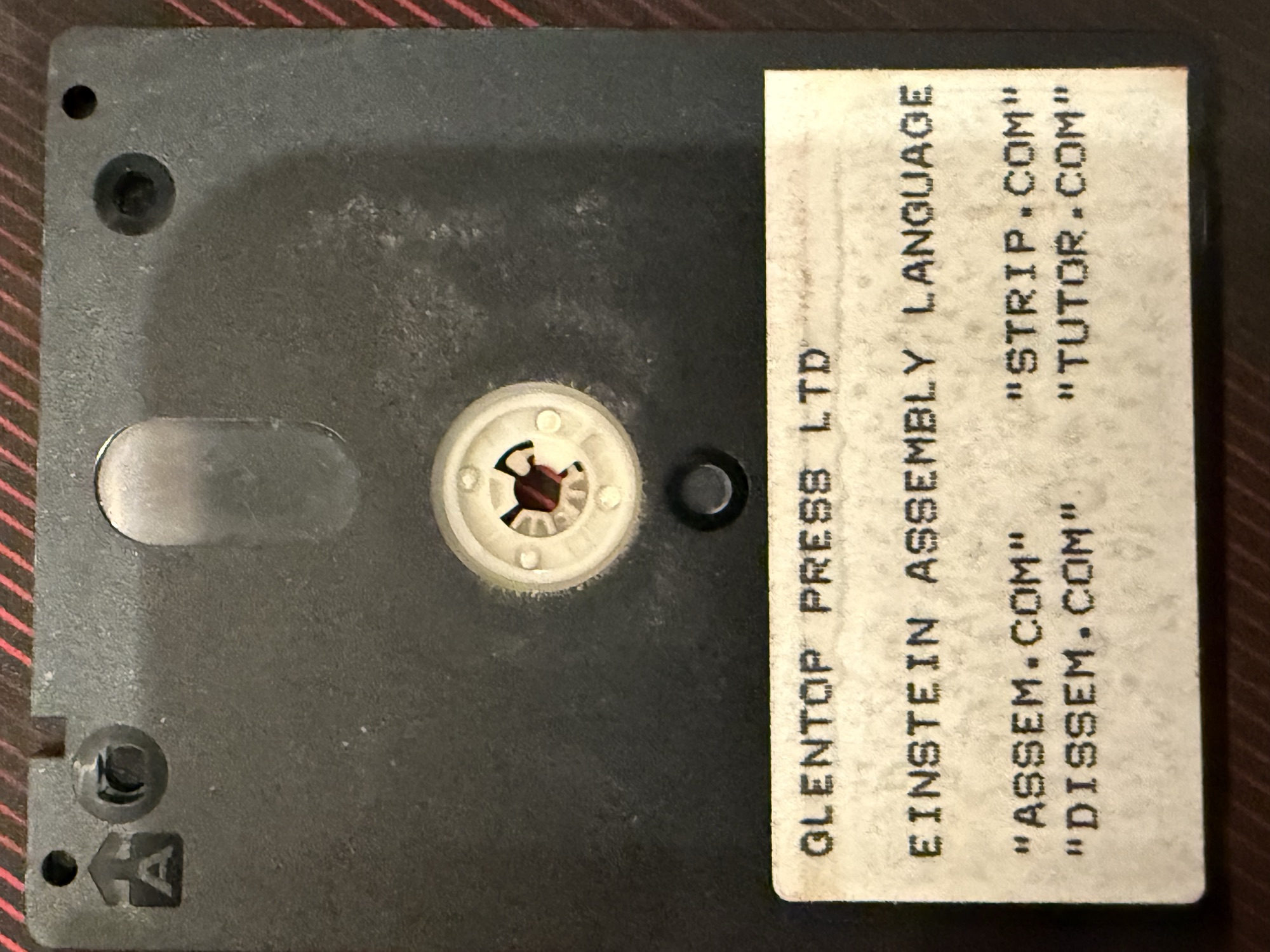 Disc label: Glentop Press Ltd, Einstein Assembly Language, ASSEM.COM, DISSEM.COM, STRIP.COM, TUTOR.COM