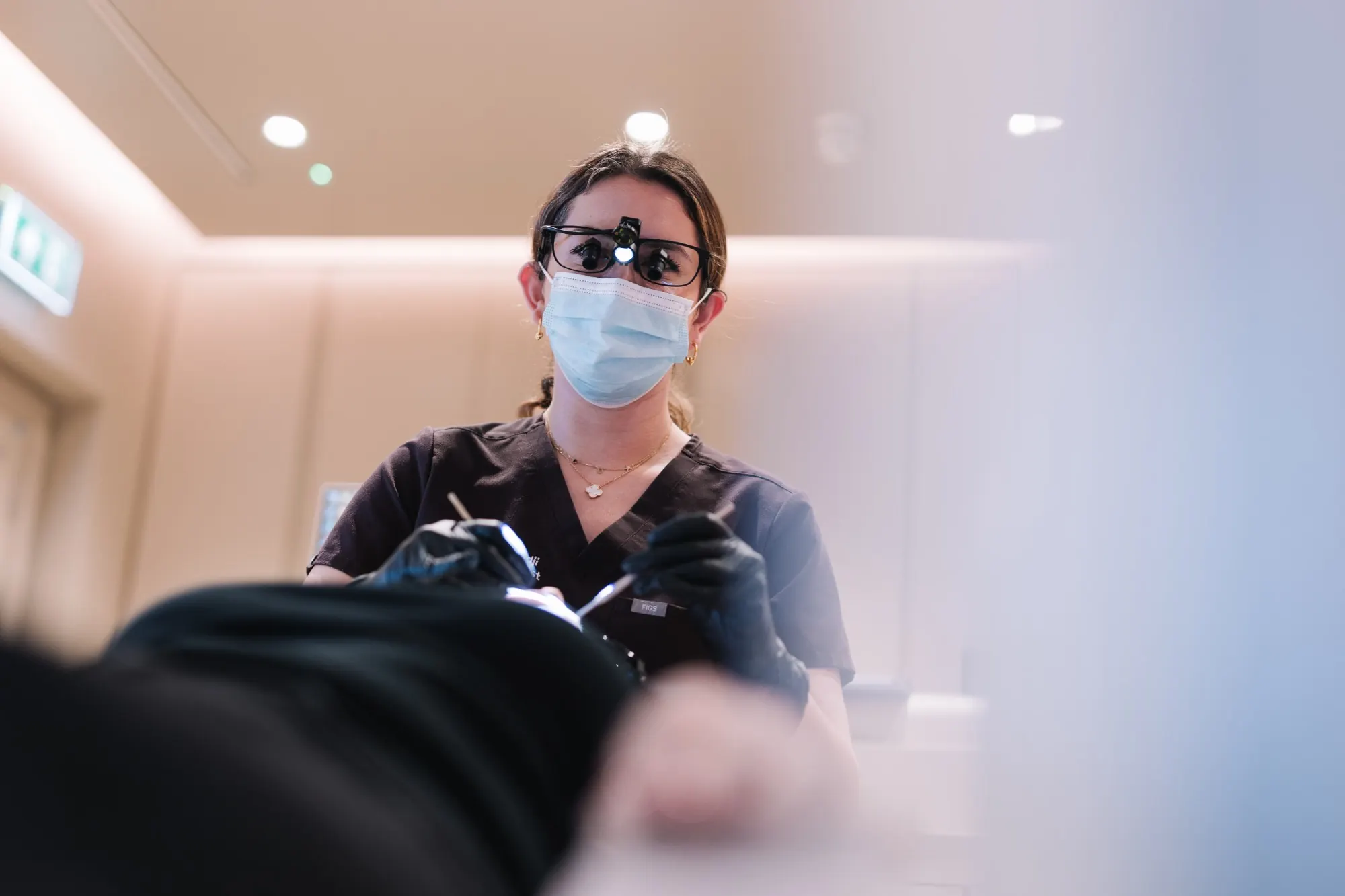 Dr Payvand Menhadji examining a patient