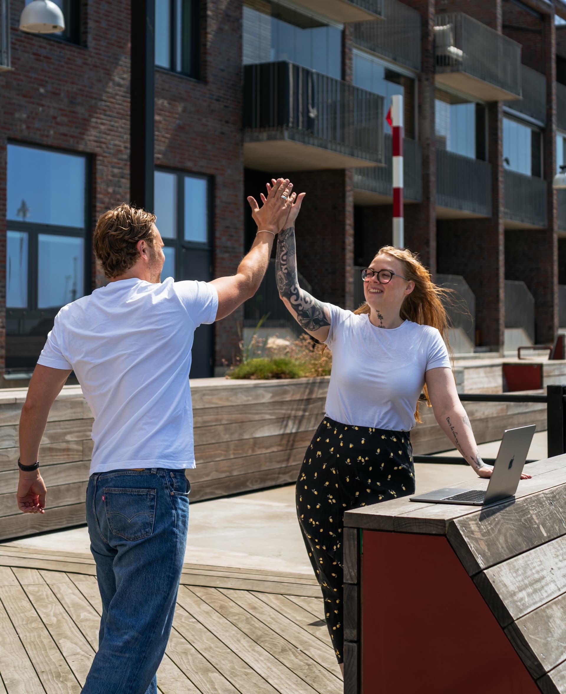 Theo och Mikaela ger varandra en high five vid en laptop i Malmö.