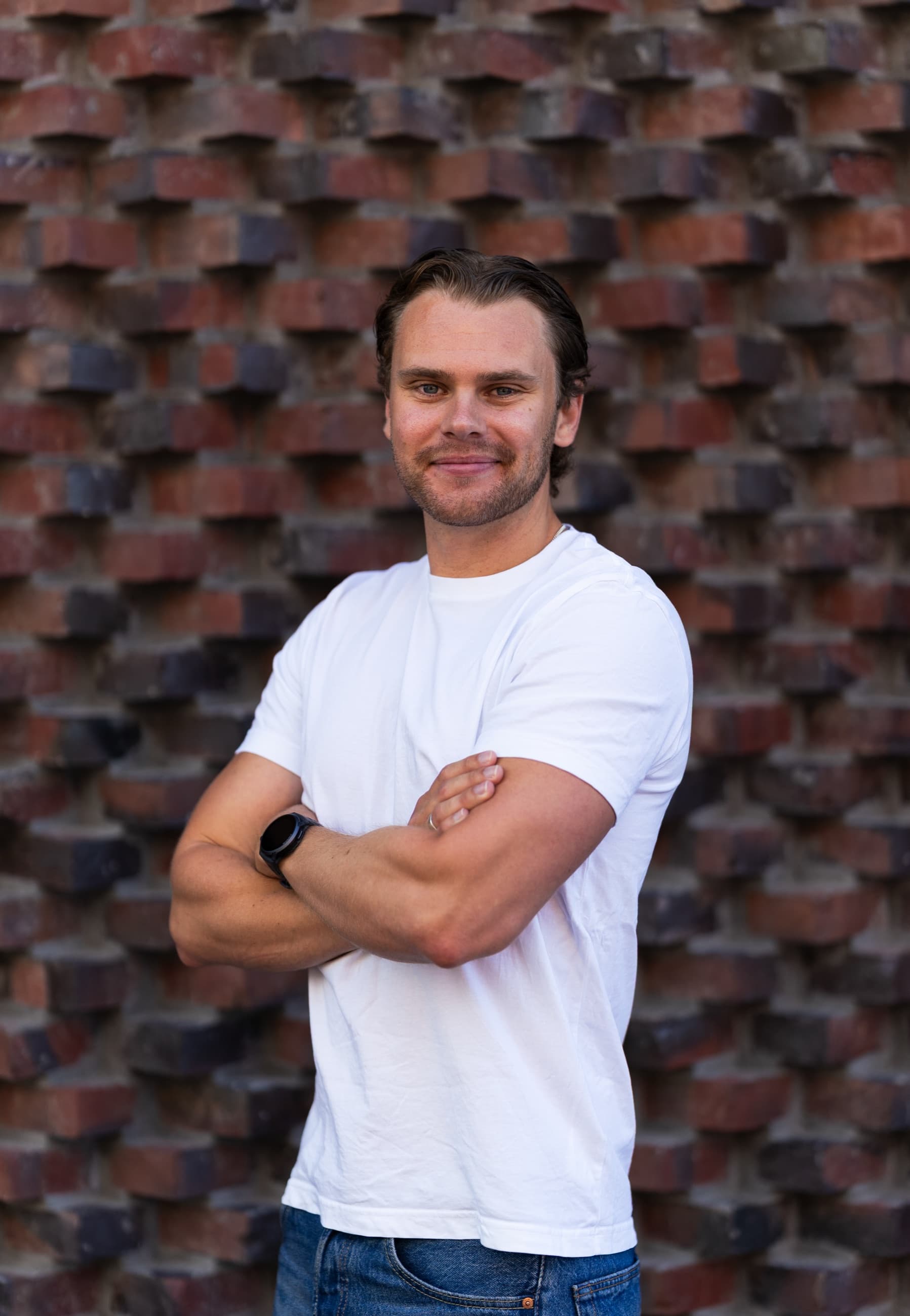 Theo Skogsberg framför en tegelvägg.