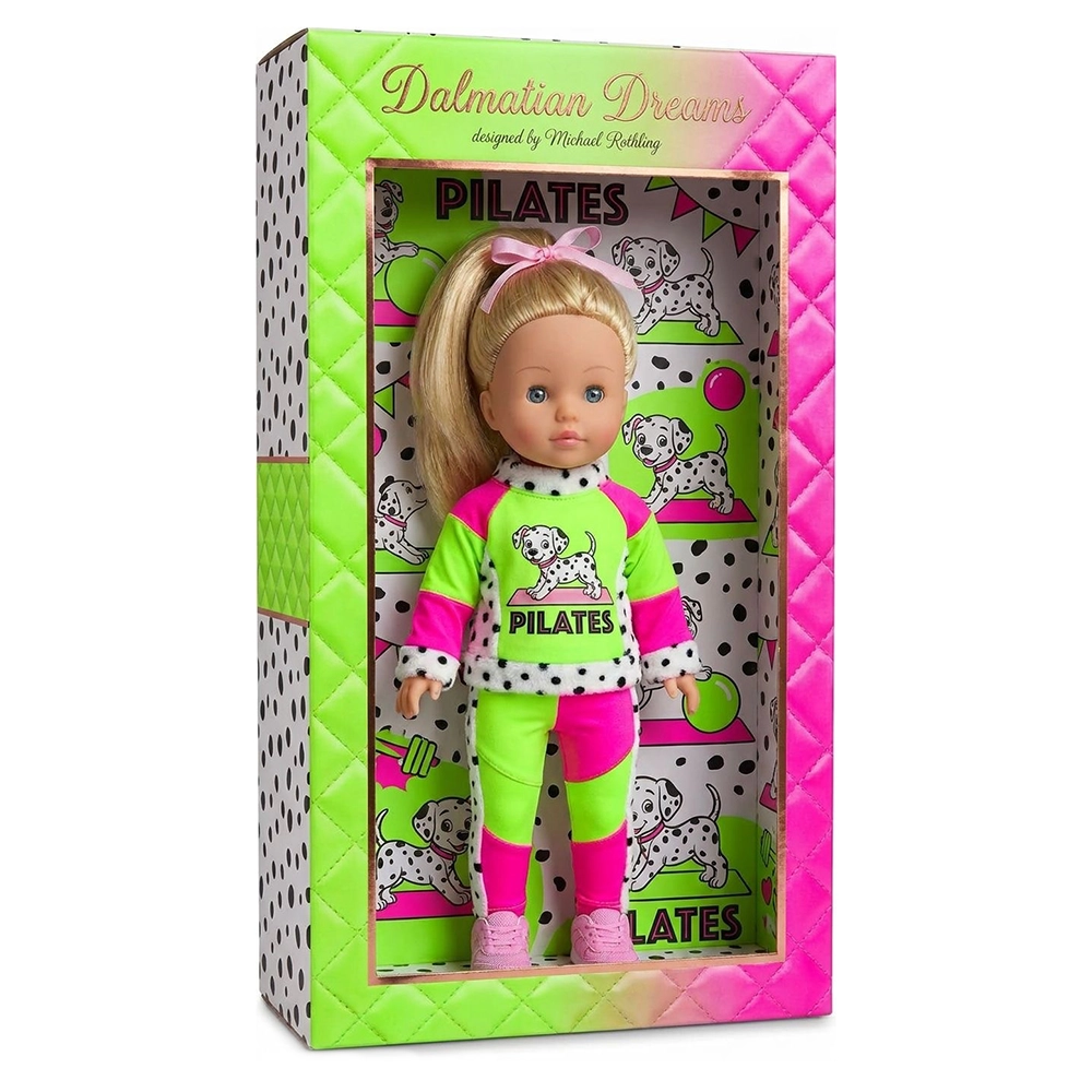 Blonde doll in pink and green Pilates outfit with Dalmatian dog pattern standing in colorful box.