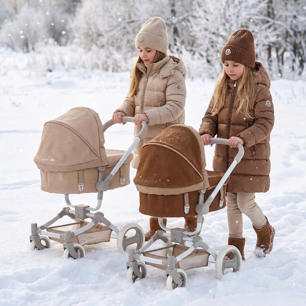 Two children dressed in winter clothes, including jackets and knit hats, each pushing a stroller in the snow with a frosty forest background.