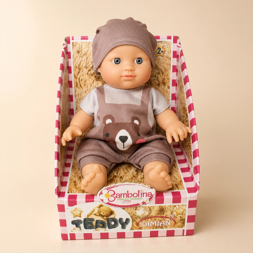 Baby doll wearing brown hat and bear overalls sitting in pink striped box labeled Teddy Dimian.
