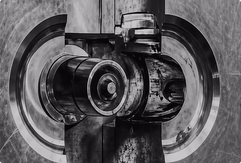 Close-up black and white photo of the intricate locking mechanism of a heavy metal bank vault door.