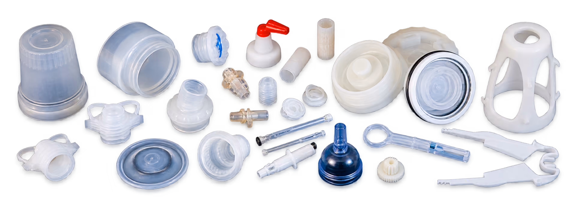 Variety of plastic medical and lab components including caps, connectors, valves, and containers, arranged on a white background.