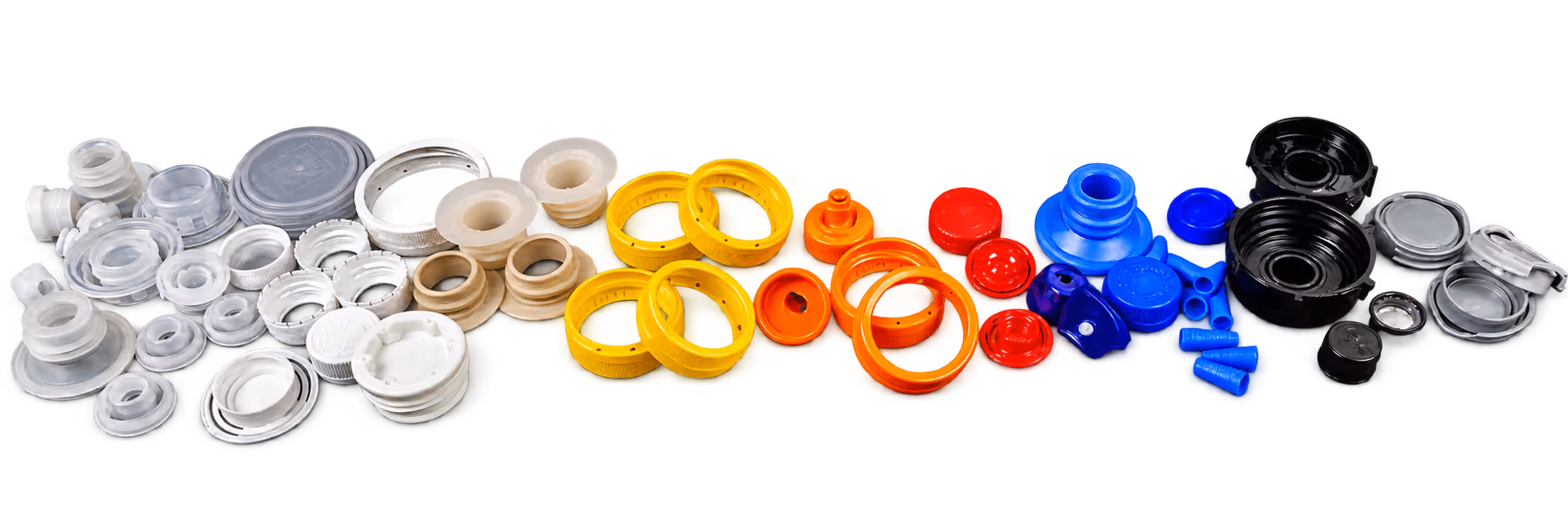 A collection of industrial plastic and rubber seals, gaskets, and washers in various shapes and sizes arranged in a row by color including white, beige, yellow, orange, red, blue, and black.