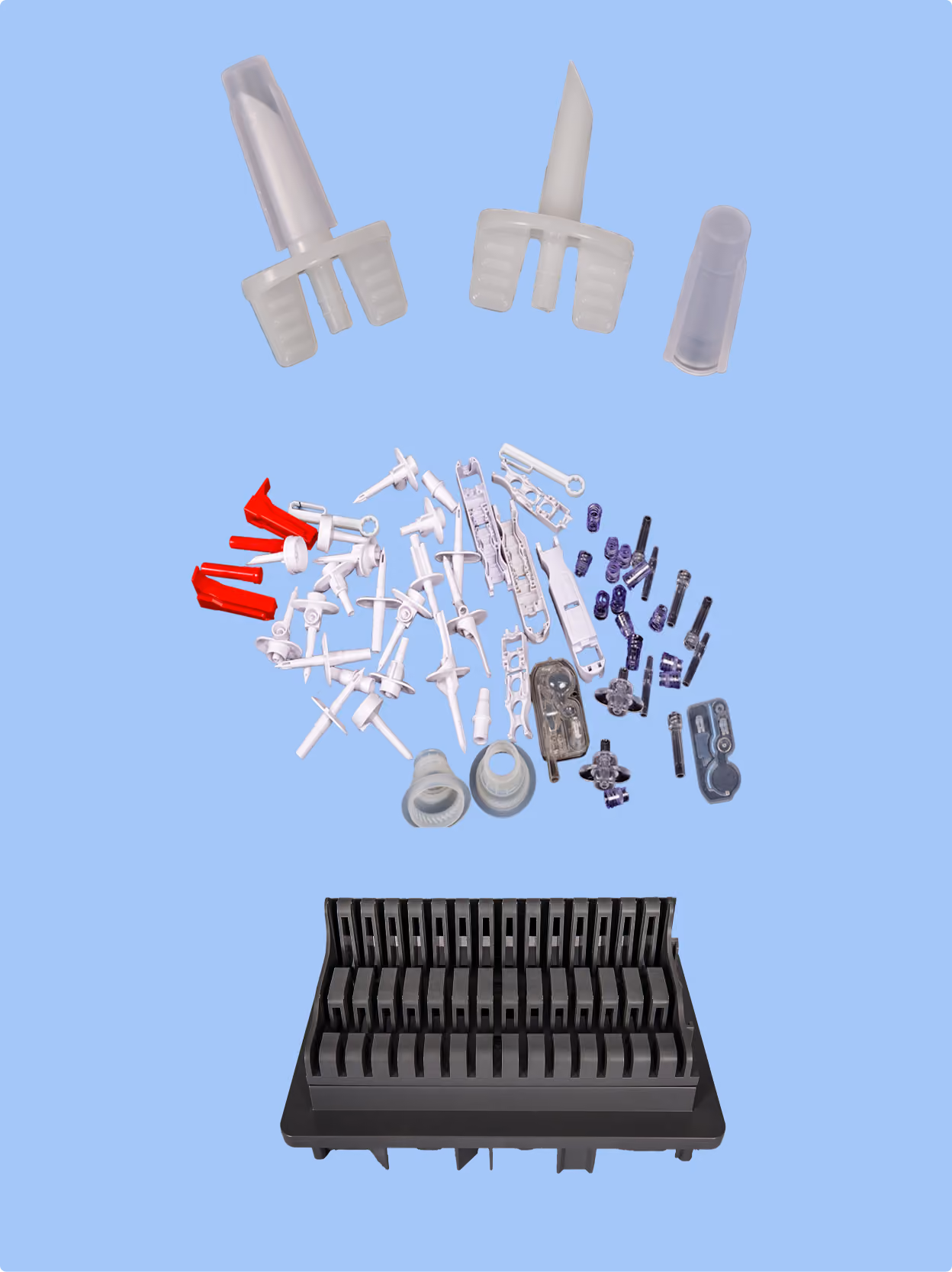 A collection of assorted plastic and metal electronic or mechanical components arranged above a black plastic rack against a light blue background.