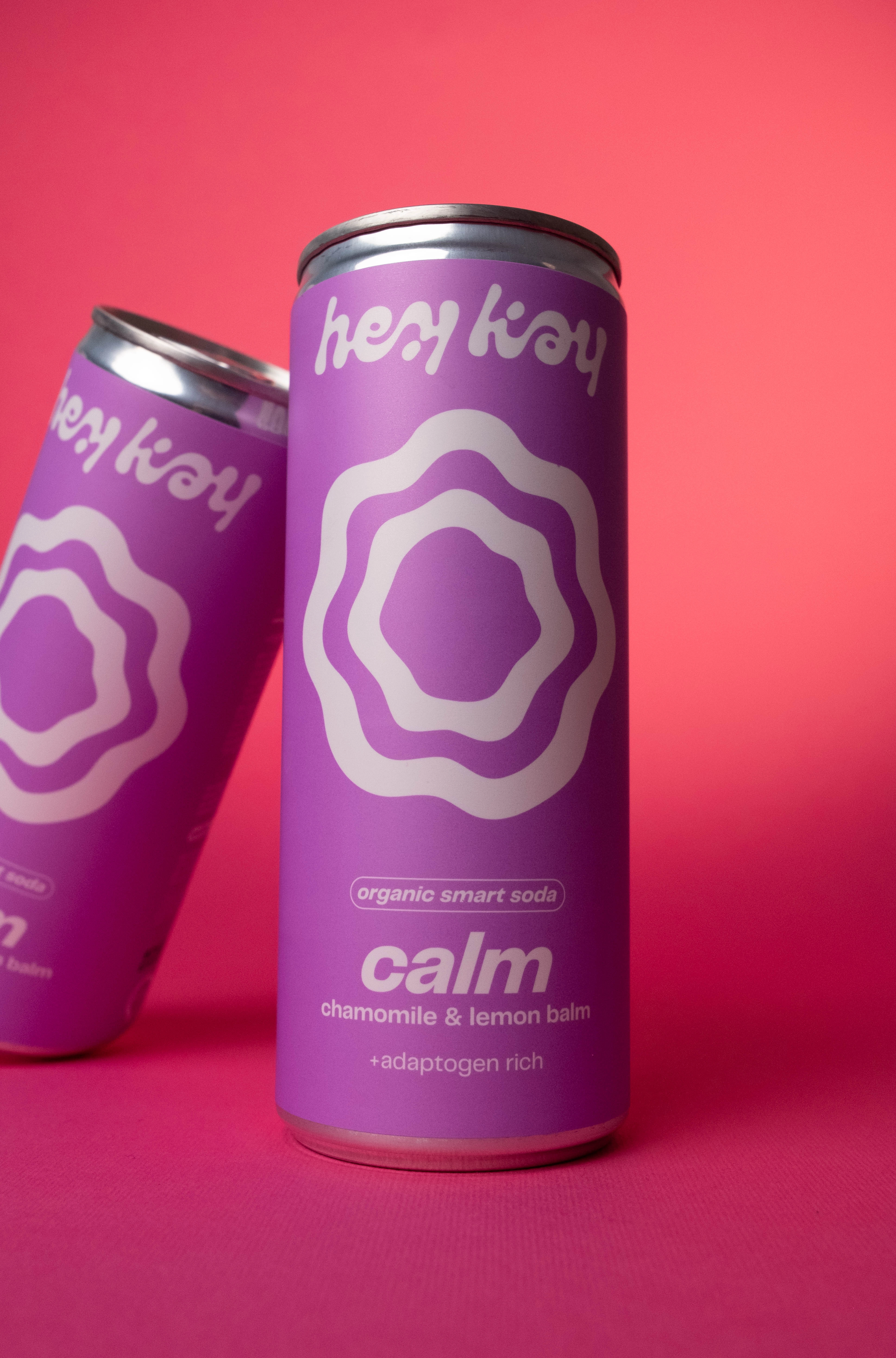 Two tilted hey kay calm cans, close-up