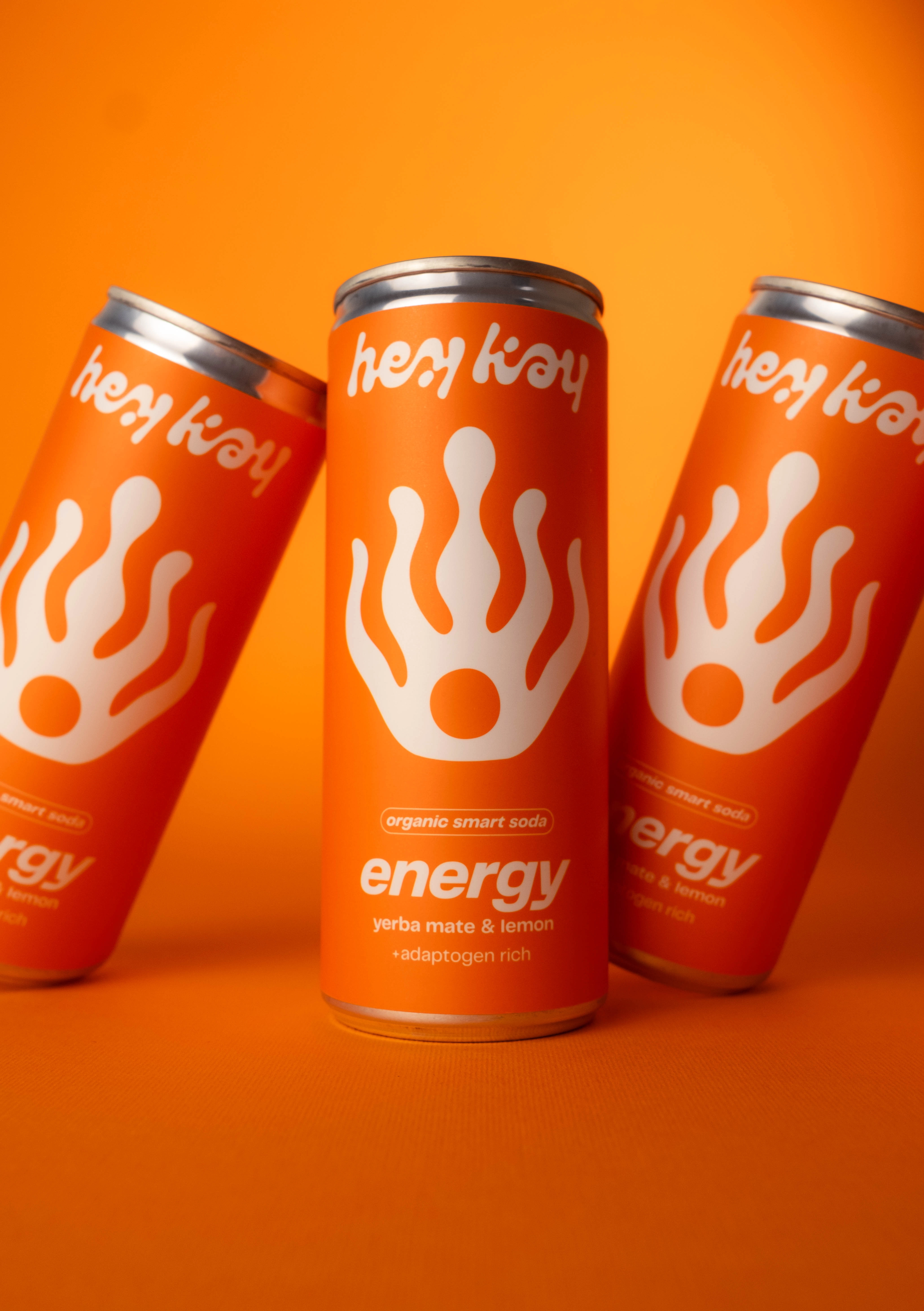 Three tilted hey kay energy cans
