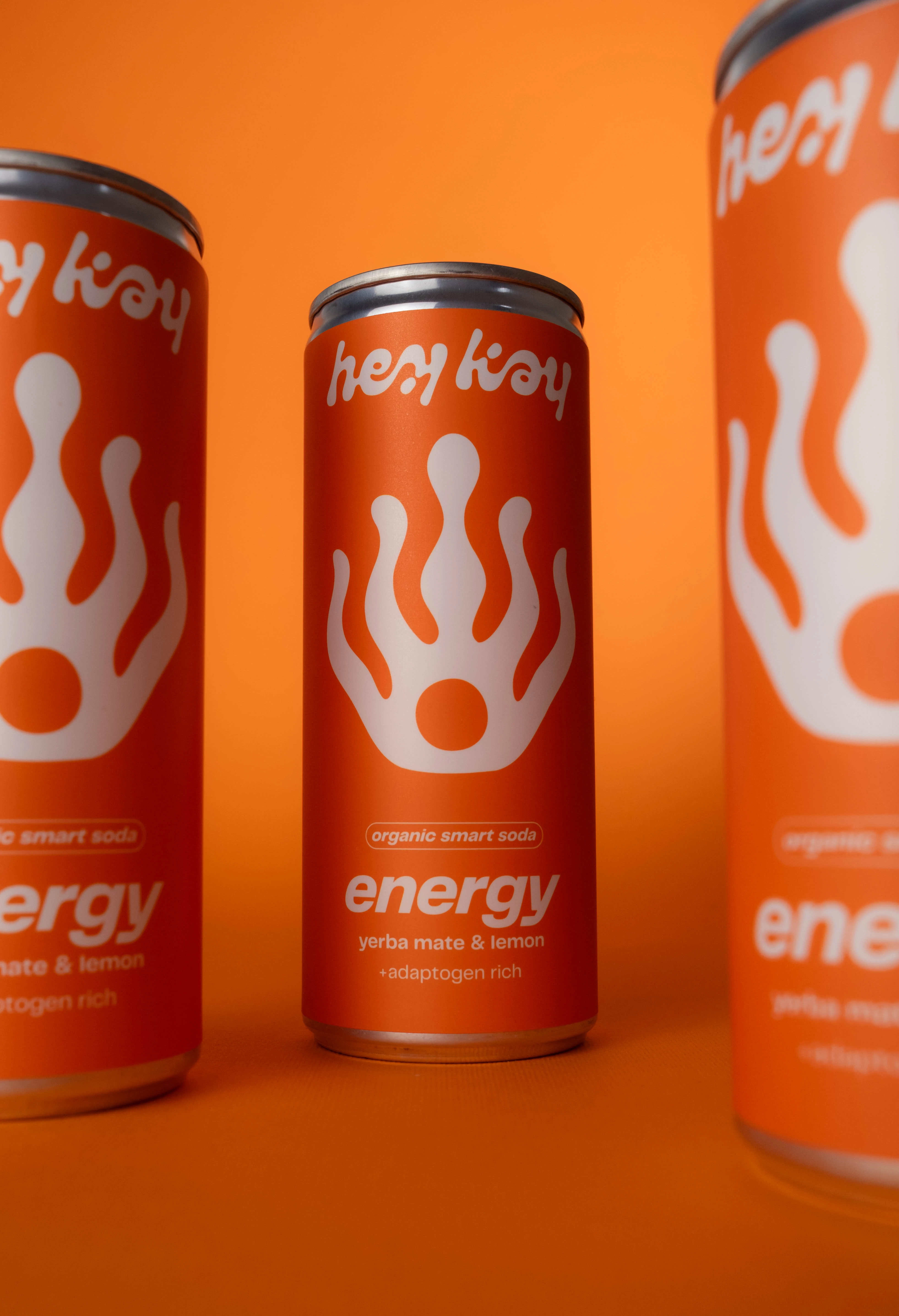 hey kay energy can among other cans, on an orange background