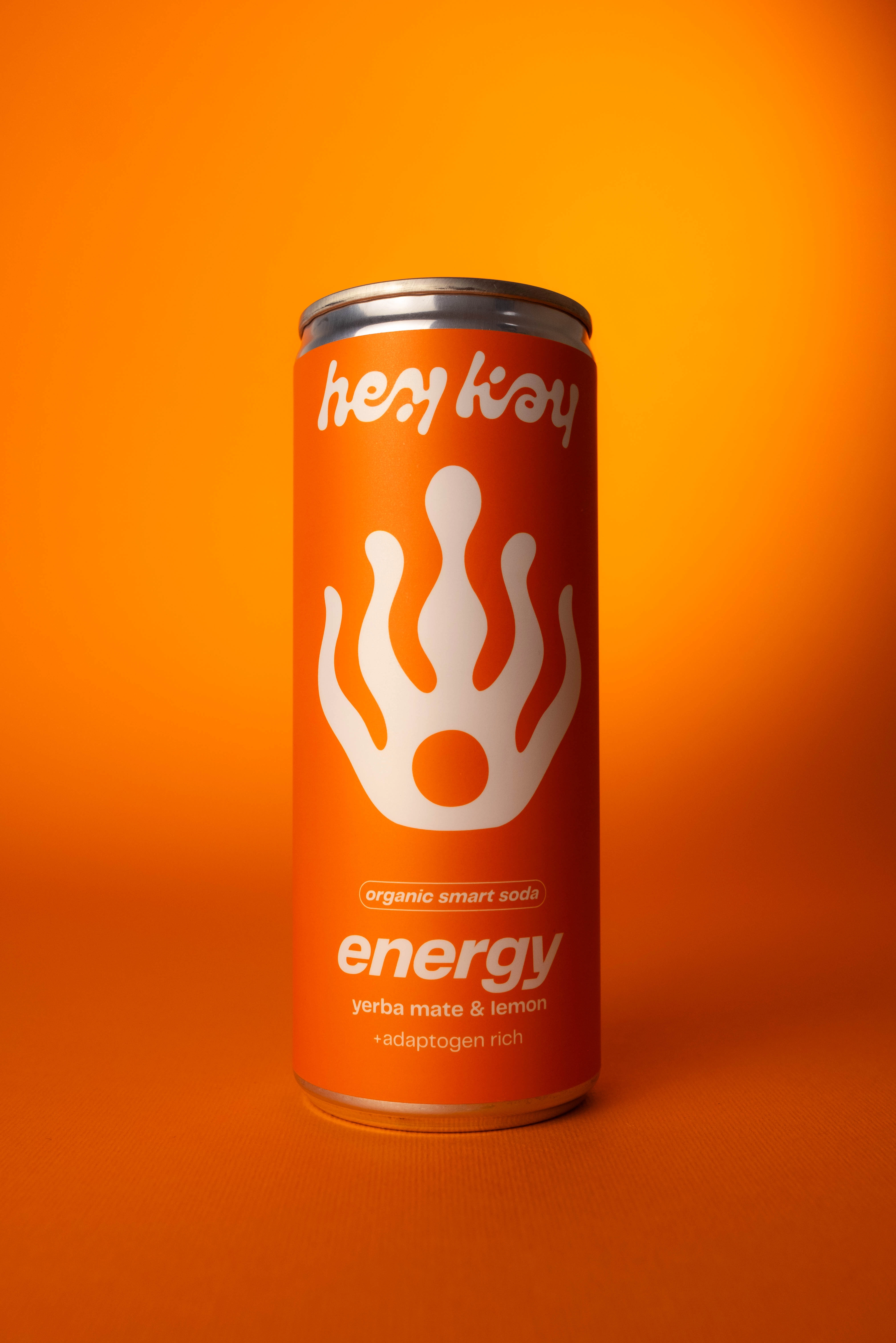 Close-up of a hey kay energy can on an orange background