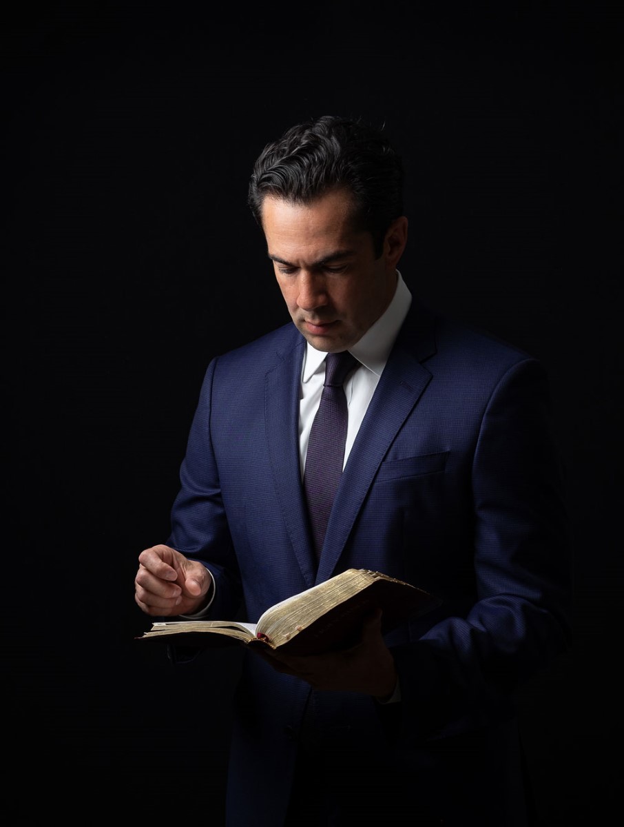 Marco Crawford, professional attorney and lawyer, reading legal documents