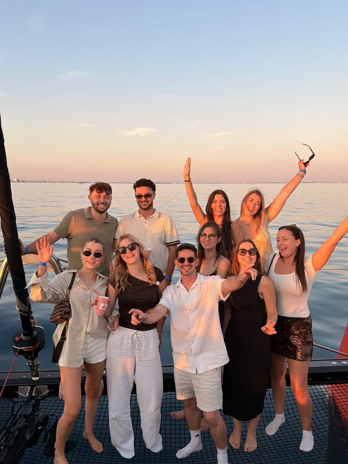 The Lumera team gathered on a boat at sunset