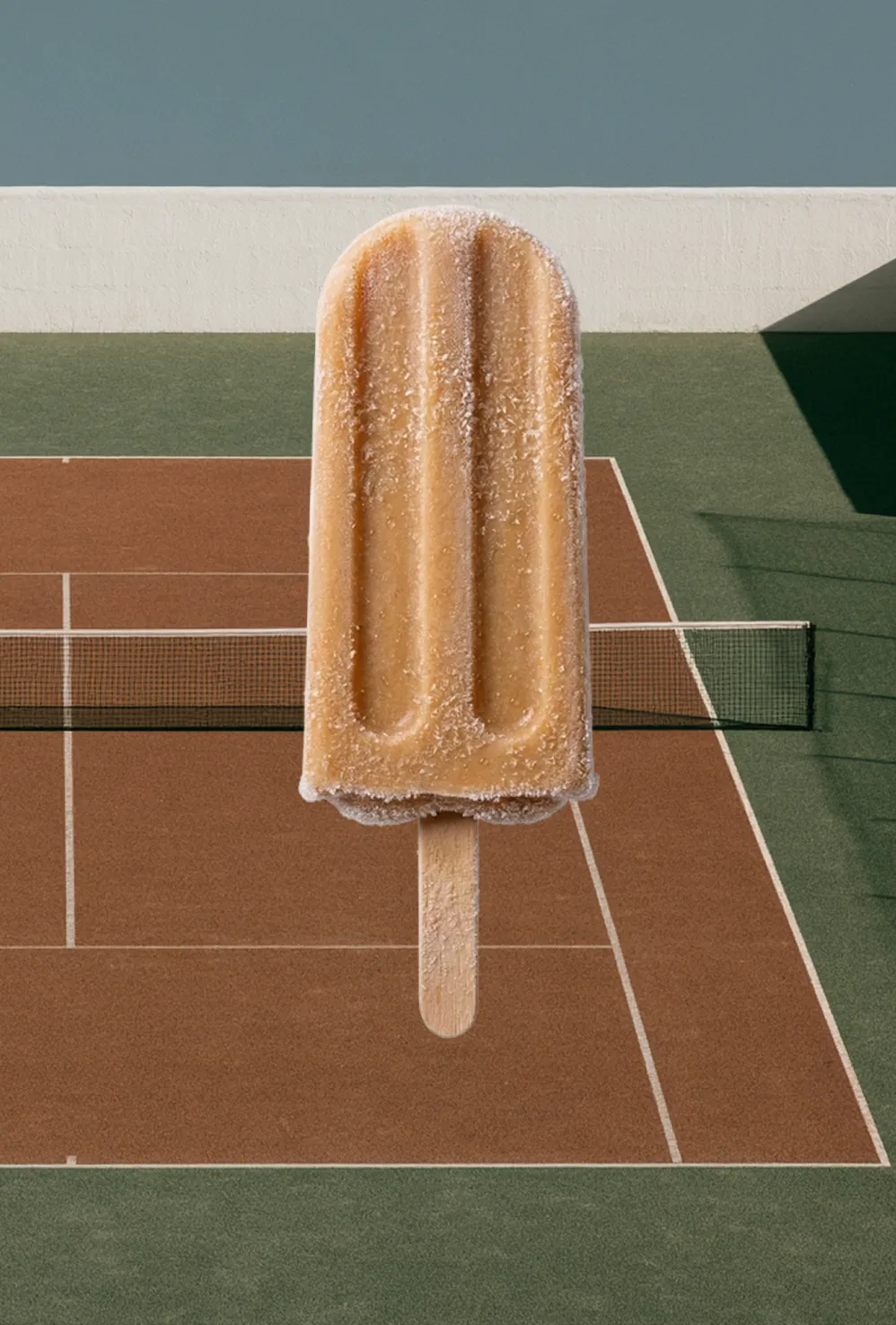 Surreal image of a giant frosted popsicle towering over a clay tennis court