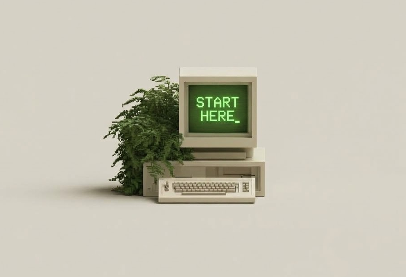 Vintage beige computer with green screen displaying the text 'START HERE_' and a lush green plant growing behind it, set against a plain beige background.