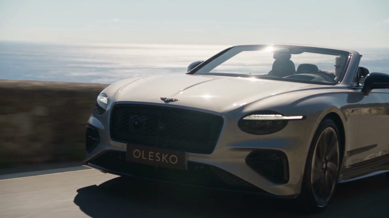 Silver Bentley Continental GTC on a Mediterranean cliff road