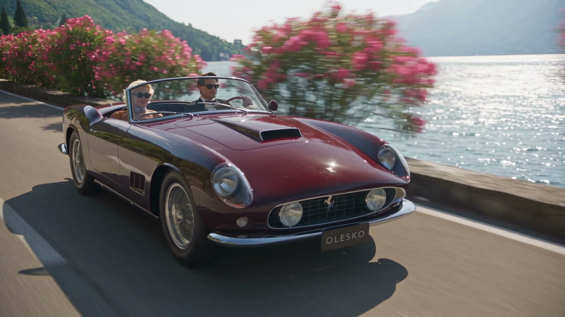 Burgundy Ferrari 250 GT California Spyder on the Lake Como road