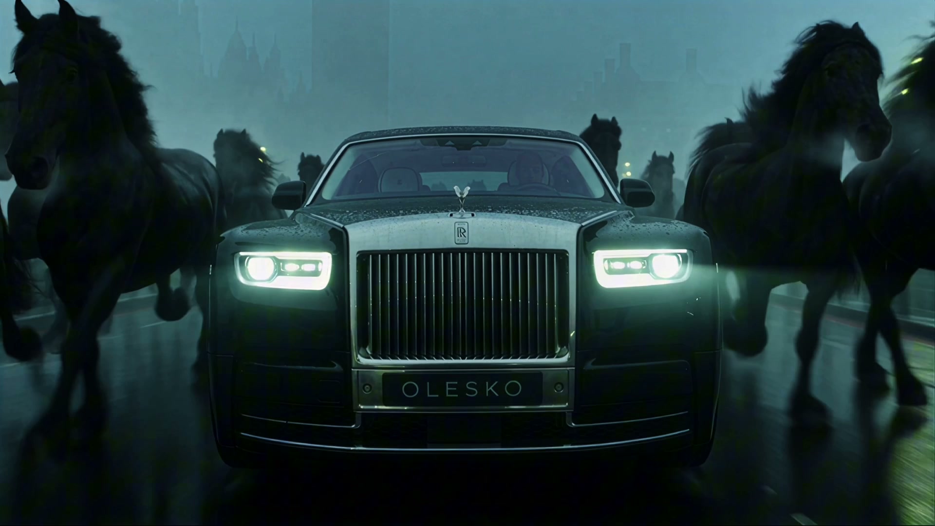 Black Rolls-Royce Phantom with an OLESKO plate facing the camera on a wet London road, horses in fog