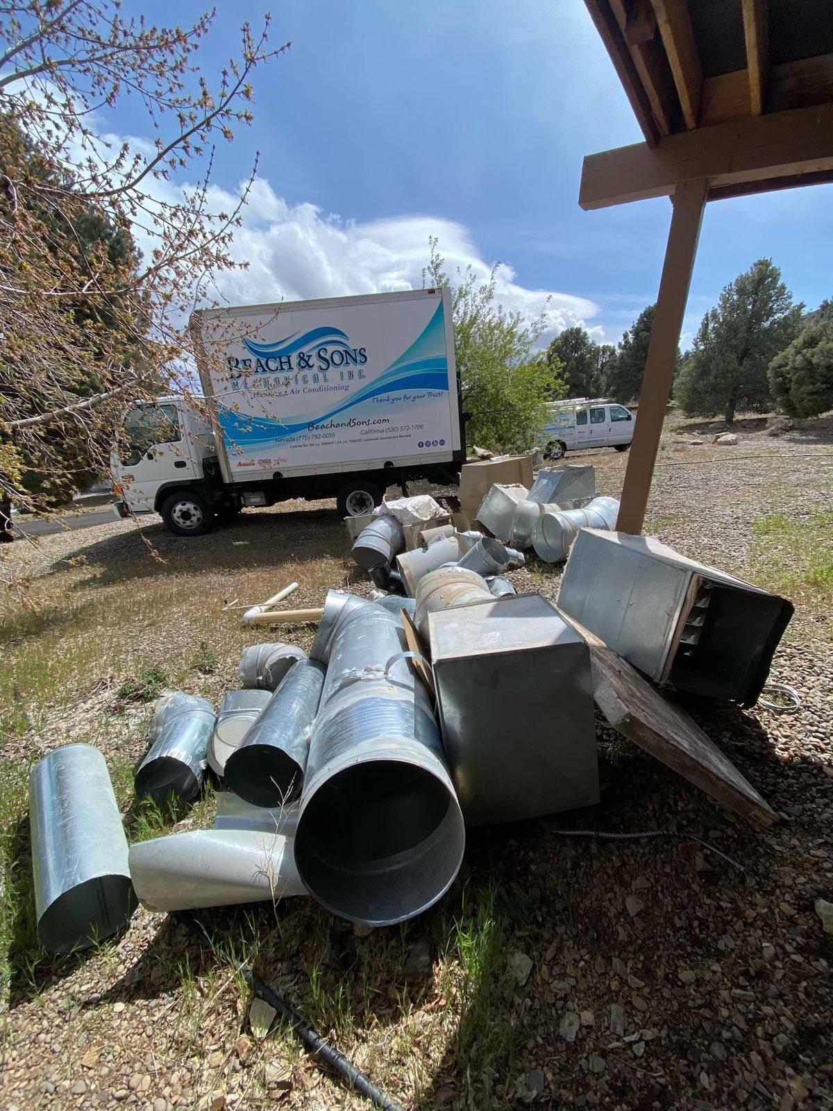 Removed old ductwork staged next to a Beach and Sons truck for haul-away