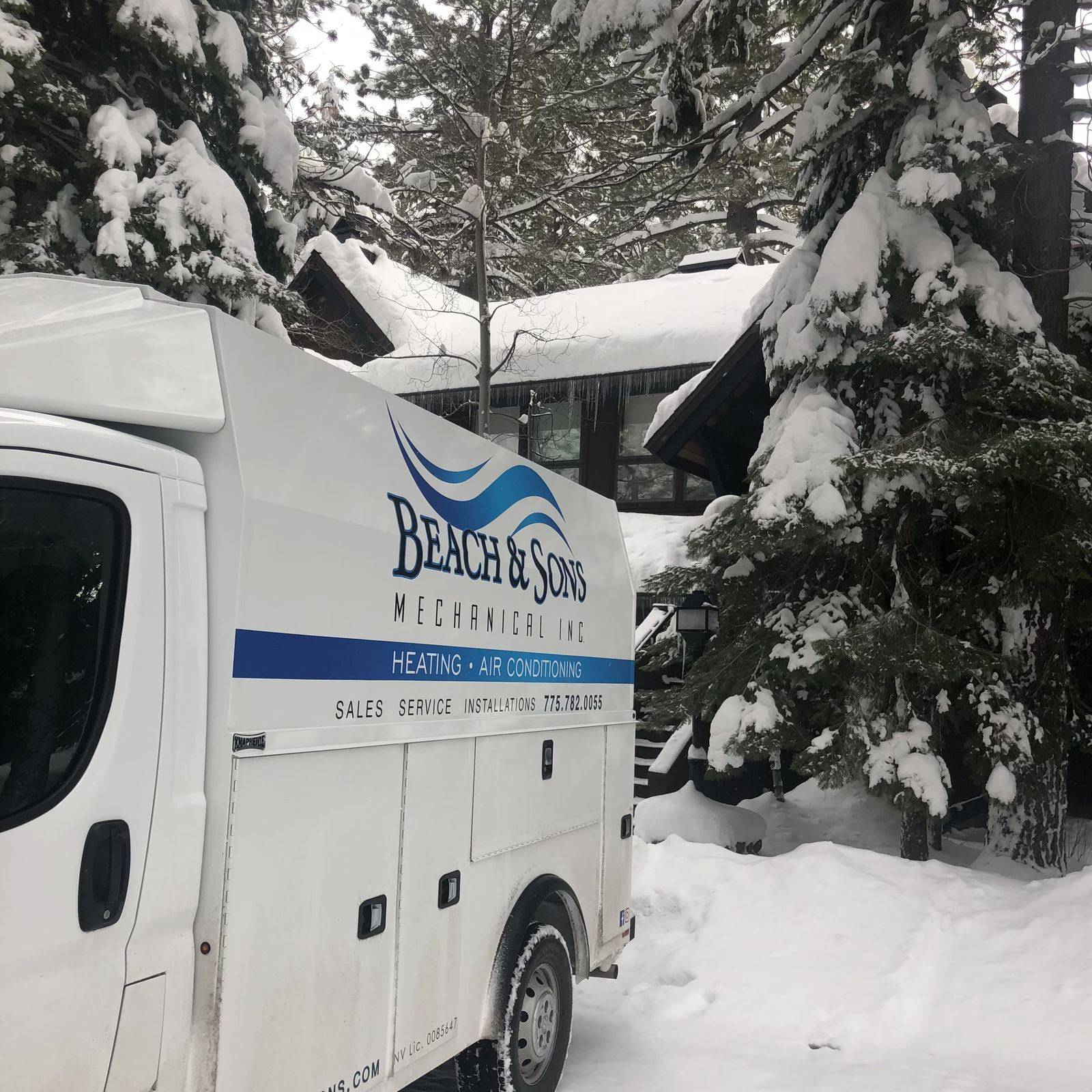 Beach and Sons Mechanical service van with snow-covered trees