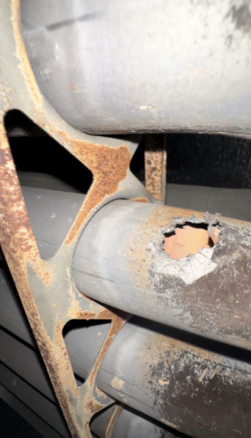 Hole rusted through a furnace burner assembly