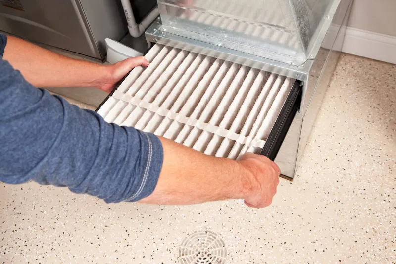 A technician pulling out a filter.