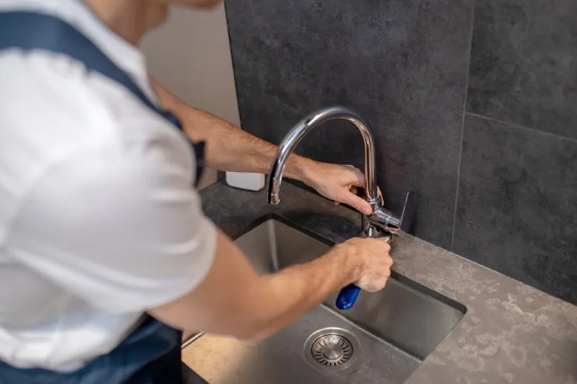 A handyman fixing a sink