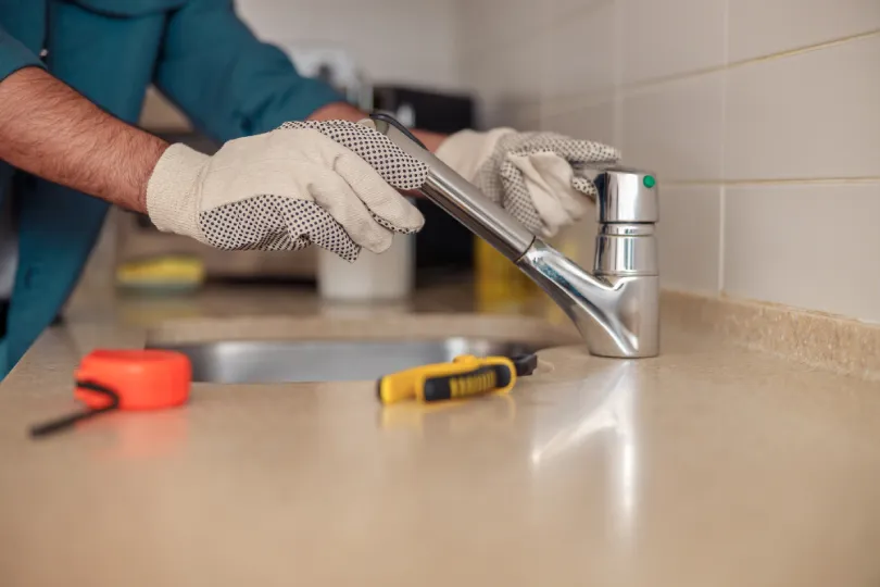 A plumber repairing a kitchen sink