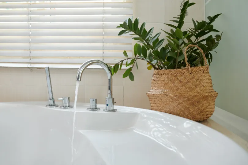 A bathtub with water coming out of the faucet.
