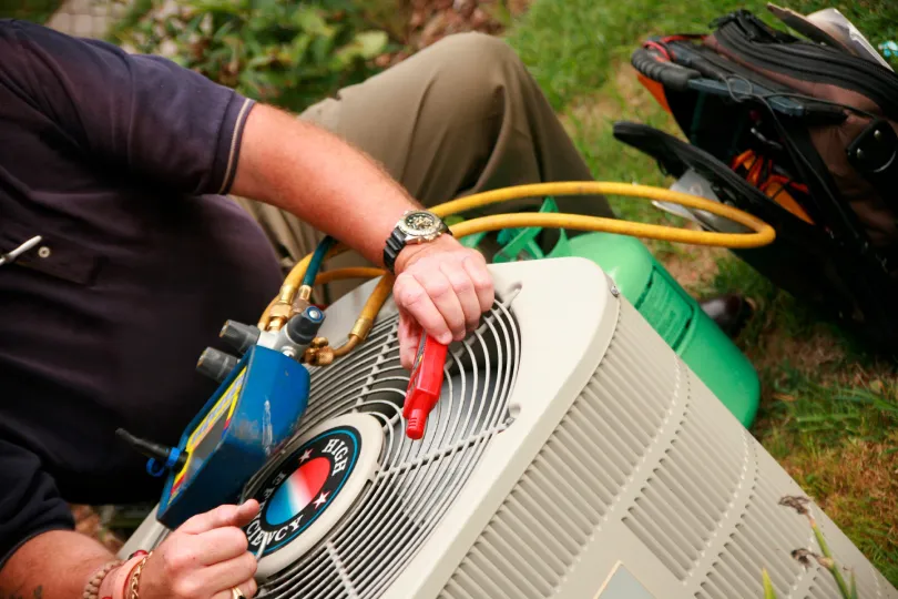 A technician working on repairing an AC unit.