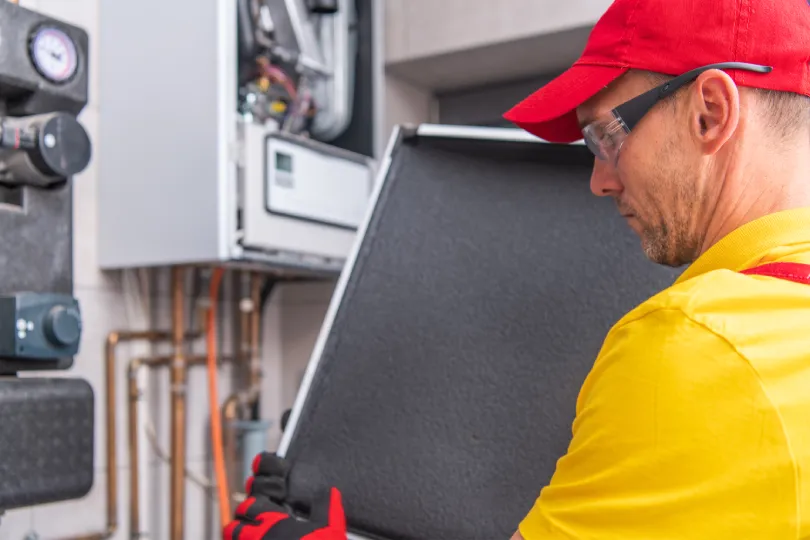 A technician working on a furnace