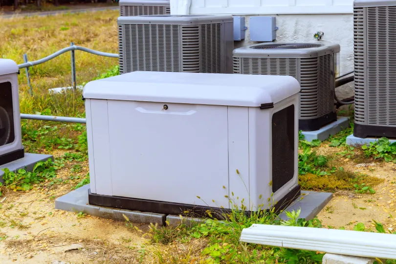 A generator next to air conditioners.