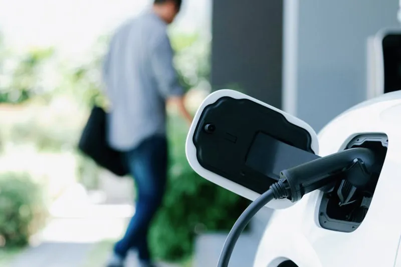 An electric car plugged in at home