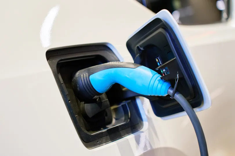 A charging plug plugged into an electric car